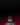 Person wearing a black jacket with 'BULLS' text on a dark background