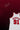 White basketball jersey with red text on a dark background