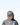 Person wearing a gray cap and jacket with a logo on a light blue background