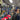 Man in a hat store surrounded by various hats and caps on display.