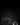 Black baseball jerseys with logos on a dark background